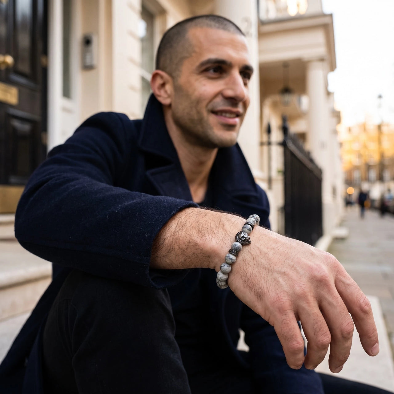 Black Lion & Grey Stones Bracelet – worn by a man sitting | Brother & Sisters | SKU: 20866222-gun-black-XS-14-15, 20866222-gun-black-S-16-17, 20866222-gun-black-M-18-19, 20866222-gun-black-L-20-21, 20866222-gun-black-XL-22-23