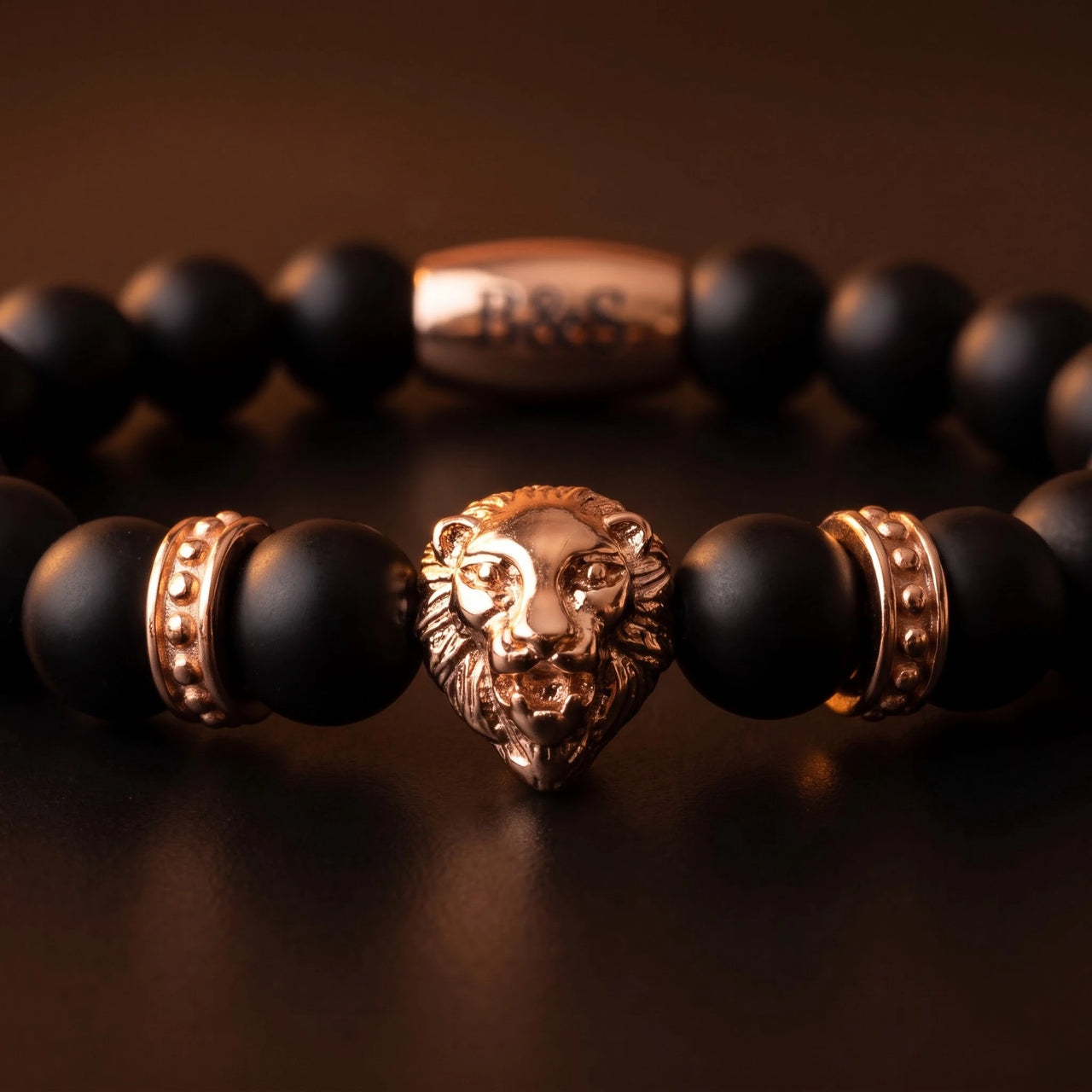 Rose Gold Lion & Black Stones Bracelet – macro detail of the lion head | Brother & Sisters | SKU: 20712286-rose-gold-XS-14-15, 20712286-rose-gold-S-16-17, 20712286-rose-gold-M-18-19, 20712286-rose-gold-L-20-21, 20712286-rose-gold-XL-22-23