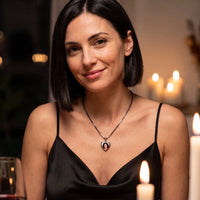 Thumbnail for Woman at a candlelit dinner wearing the black secret heart photo necklace | SKU: TPH-CHTN-BLACK-SMALL