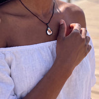 Thumbnail for Woman in an off-shoulder white top touching the black teardrop pendant to reveal the photo | SKU: TPH-DRPN-BLACK