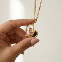 Thumbnail for Secret heart photo pendant held between two fingers, showing its real small size | SKU: TPH-HRTN-GOLD